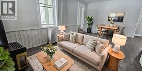 Cambridge apartment for rent - A living room with a beige couch, a coffee table with a vase of flowers, and a lamp on a side table.