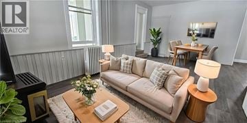 Cambridge apartment for rent - A living room with a beige couch, a coffee table with a vase of flowers, and a lamp on a side table.