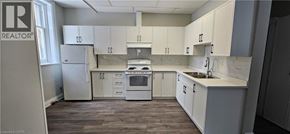 Cambridge apartment for rent - A kitchen with white cabinets and a marble countertop.