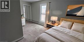 Cambridge apartment for rent - A bedroom with a bed, nightstand, and a painting on the wall.