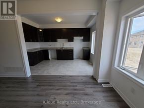 Southgate apartment for rent - A room with a kitchen area and a large window.
