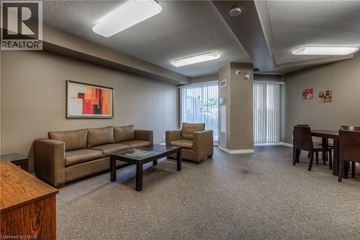 Cambridge condo for rent - A living room with a brown sofa, a coffee table, and a painting on the wall.