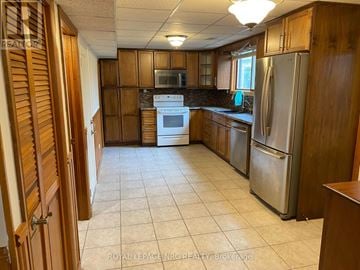 Niagara Falls (Morrison) apartment for rent - A kitchen with wooden cabinets and a tile floor.
