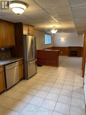 Niagara Falls (Morrison) apartment for rent - A kitchen with tile flooring and wooden cabinets.