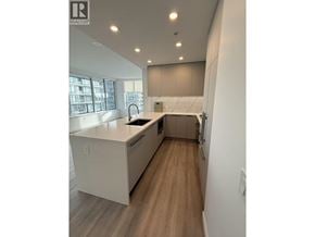 New Westminster apartment for rent - A modern kitchen with white cabinets and a wooden floor.