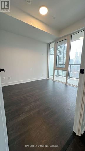 Toronto (Church-Yonge Corridor) condo for rent - A room with wooden flooring and a large window.