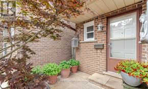 Mississauga (Rathwood) apartment for rent - A small front yard with a red door and a mailbox.