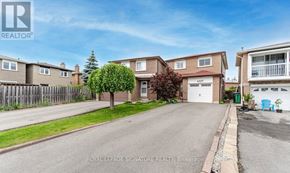 Mississauga (Rathwood) apartment for rent - A residential street with houses and a clear sky.