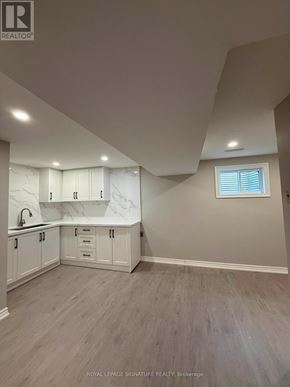 Mississauga (Rathwood) apartment for rent - A kitchen with white cabinets and a window.