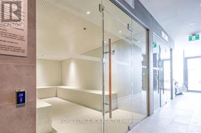 Barrie (City Centre) condo for rent - A glass door with a handle and a sign on the wall.