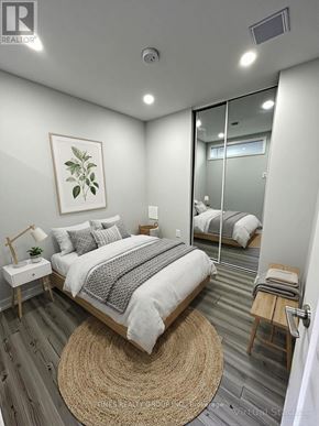 Toronto (Annex) multi-family for rent - A bedroom with a bed, nightstand, and a rug.