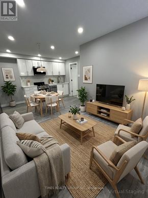 Toronto (Annex) multi-family for rent - A modern living room with a grey couch, wooden chairs, and a television.