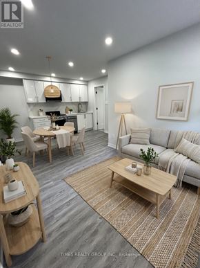 Toronto (Annex) multi-family for rent - A well-lit, modern living room with a dining area and a kitchen in the background.