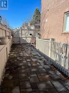 Richmond Hill (Westbrook) apartment for rent - A brick building with a white fence and a sign that says "REALTOR" in the top left corner.
