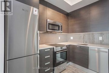 Toronto (Church-Yonge Corridor) condo for rent - A modern kitchen with stainless steel appliances and a microwave above the oven.
