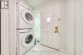 Toronto (Oakridge) apartment for rent - A white door is open to a laundry room with a washer and dryer.
