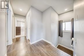 Toronto (Oakridge) apartment for rent - A well-lit, empty room with a window and a door leading to another room.