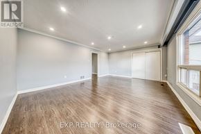 Toronto (Oakridge) apartment for rent - A room with wooden flooring and white walls, with a window on the right side.