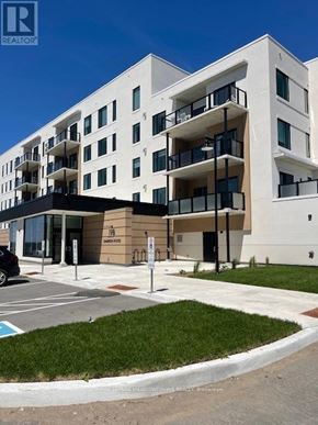 Kawartha Lakes (Fenelon Falls) condo for rent - A white building with balconies and a sign that says "REALTOR".