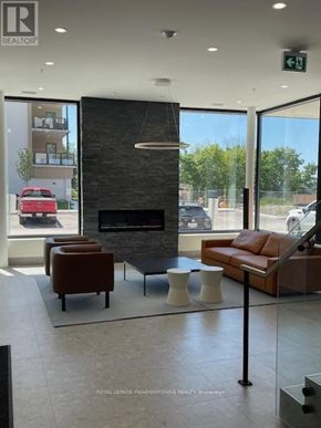 Kawartha Lakes (Fenelon Falls) condo for rent - A modern waiting room with a fireplace and comfortable seating.