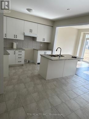 Haldimand apartment for rent - A kitchen with white cabinets and a tiled floor.