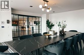 Kitchener condo for rent - A modern dining room with a long table and chairs.