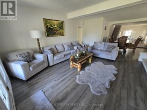 Wasaga Beach apartment for rent - A living room with a grey couch and a wooden coffee table.