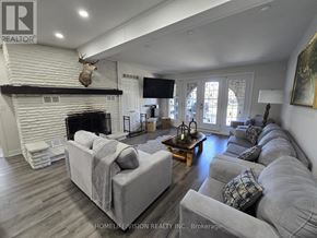 Wasaga Beach apartment for rent - A living room with a fireplace and a couch.