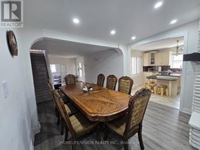 Wasaga Beach apartment for rent - A dining room with a wooden table and chairs.