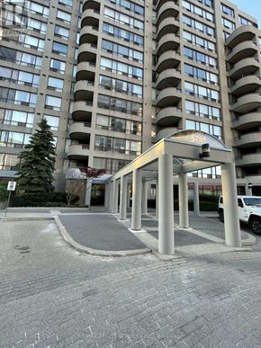 Toronto (Newtonbrook East) condo for rent - A tall building with a tree in front of it.