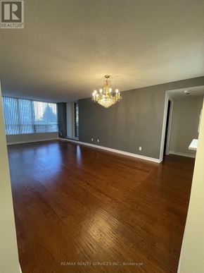 Toronto (Newtonbrook East) condo for rent - A room with wooden flooring and a chandelier.