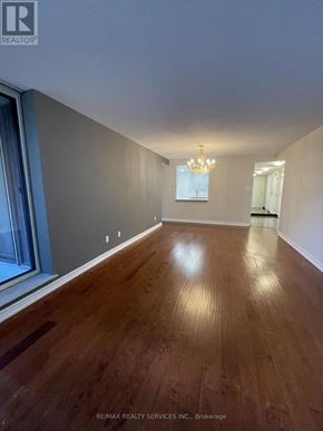 Toronto (Newtonbrook East) condo for rent - A room with wooden flooring and a chandelier.
