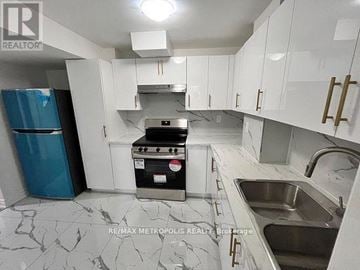 Oshawa (Eastdale) apartment for rent - A kitchen with white cabinets and a marble countertop.