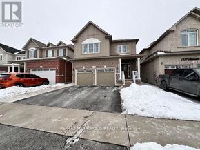 Oshawa (Eastdale) apartment for rent - A real estate photo shows a house with a driveway and garage.