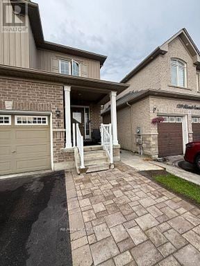 Oshawa (Eastdale) apartment for rent - A house with a garage and a driveway.
