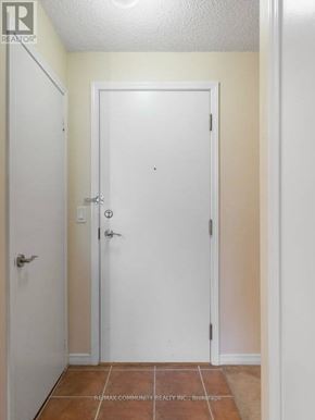 Toronto (Scarborough Village) condo for rent - A white door is in the middle of a hallway.