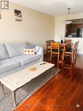 Toronto (Scarborough Village) condo for rent - A living room with a grey couch and a coffee table.