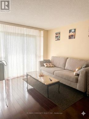 Toronto (Scarborough Village) condo for rent - A living room with a couch, coffee table, and pictures on the wall.
