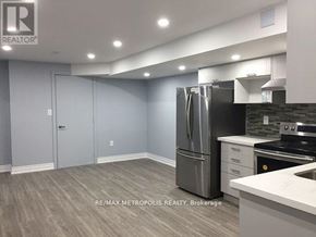 Markham (Cornell) apartment for rent - A kitchen with a refrigerator, stove, and cabinets.