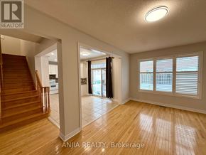Markham (Greensborough) apartment for rent - A spacious room with wooden flooring and a staircase leading to another level.