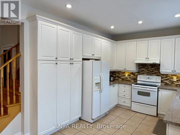 Markham (Greensborough) apartment for rent - A kitchen with white cabinets and appliances, including a refrigerator, stove, and oven.