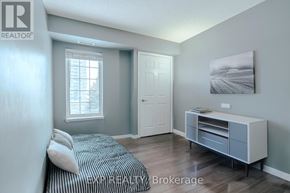 Clarington (Bowmanville) condo for rent - A bedroom with a bed, nightstand, and a cabinet.