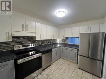 Ottawa condo for rent - A kitchen with a stove top oven and a refrigerator.