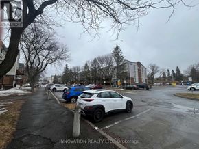Ottawa condo for rent - A white car is parked in a parking lot.