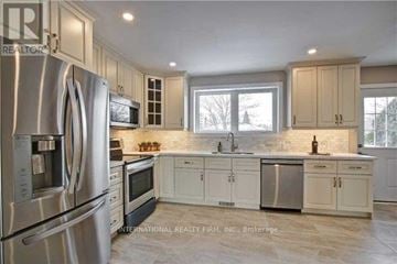 Richmond Hill (Crosby) apartment for rent - A kitchen with stainless steel appliances and white cabinets.