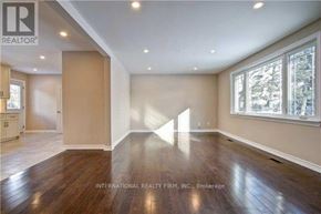 Richmond Hill (Crosby) apartment for rent - A spacious room with wooden floors and a large window.