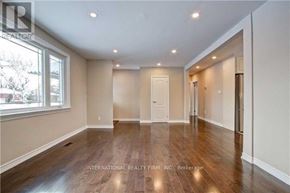 Richmond Hill (Crosby) apartment for rent - A spacious room with wooden floors and white walls.