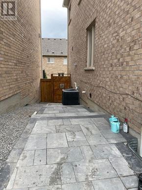 Newmarket (Stonehaven-Wyndham) apartment for rent - A narrow alley with a wooden cabinet and a trash can.
