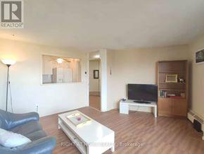 Ottawa condo for rent - A living room with a blue leather chair and a white coffee table.