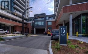 Kitchener condo for rent - A parking lot in front of a building with a sign that says 15.